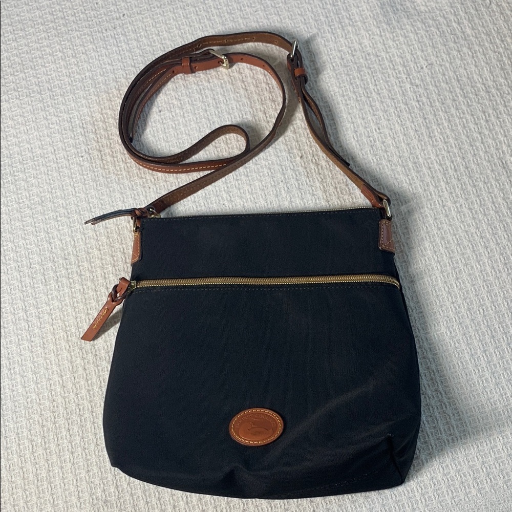 Dooney & Bourke black nylon crossbody bag with brown leather strap and accents